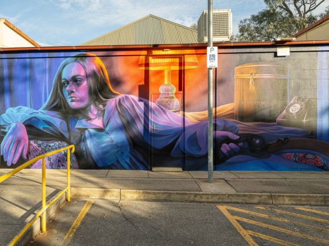 Mural of girl holding telephone