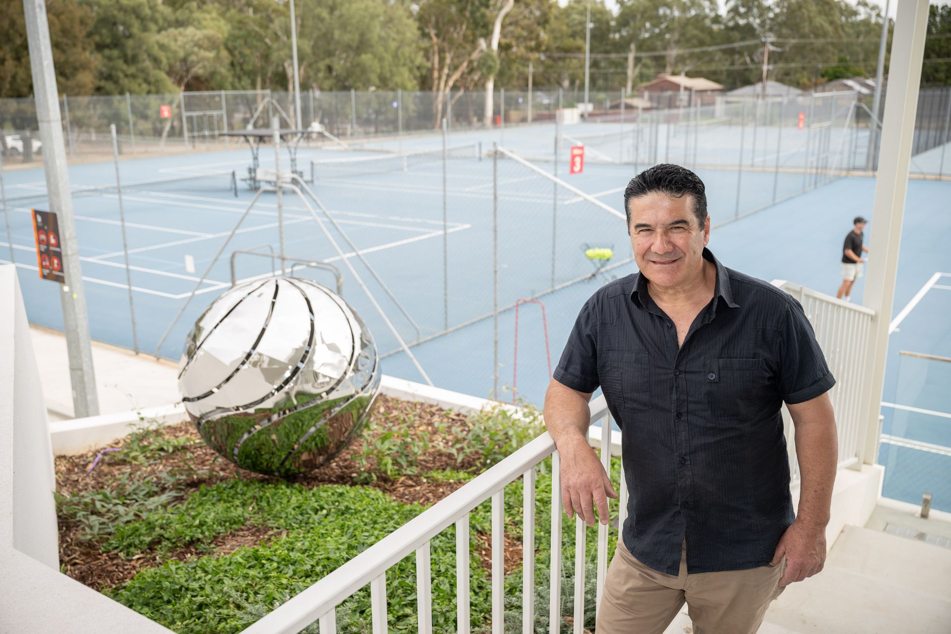 Metal sphere sculpture and artist Claude Portelli