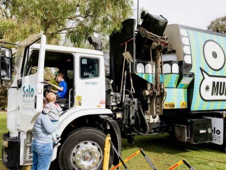 Child sitting in the cab of a Solo bin truck