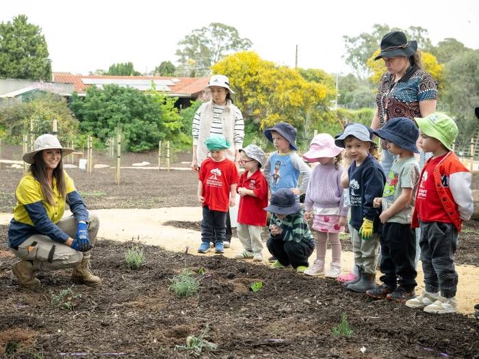 Eight kindy aged children with a Council worker