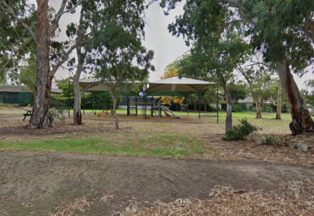 Shaded playground in reserve surrounded by trees