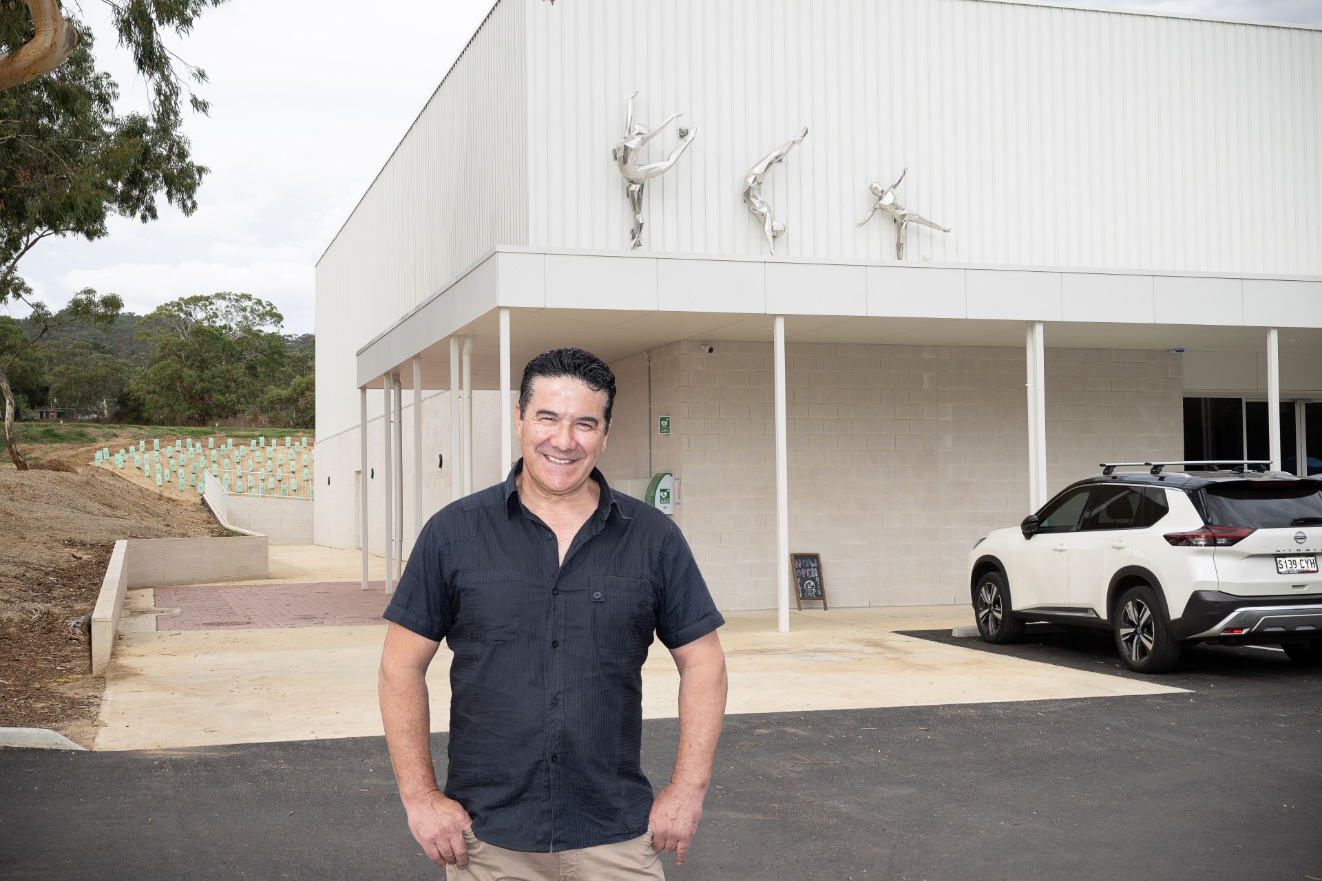 Artist Claude Portelli and the three gymnast sculptures