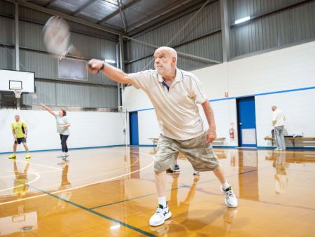 Man playing a racquet sport indoors