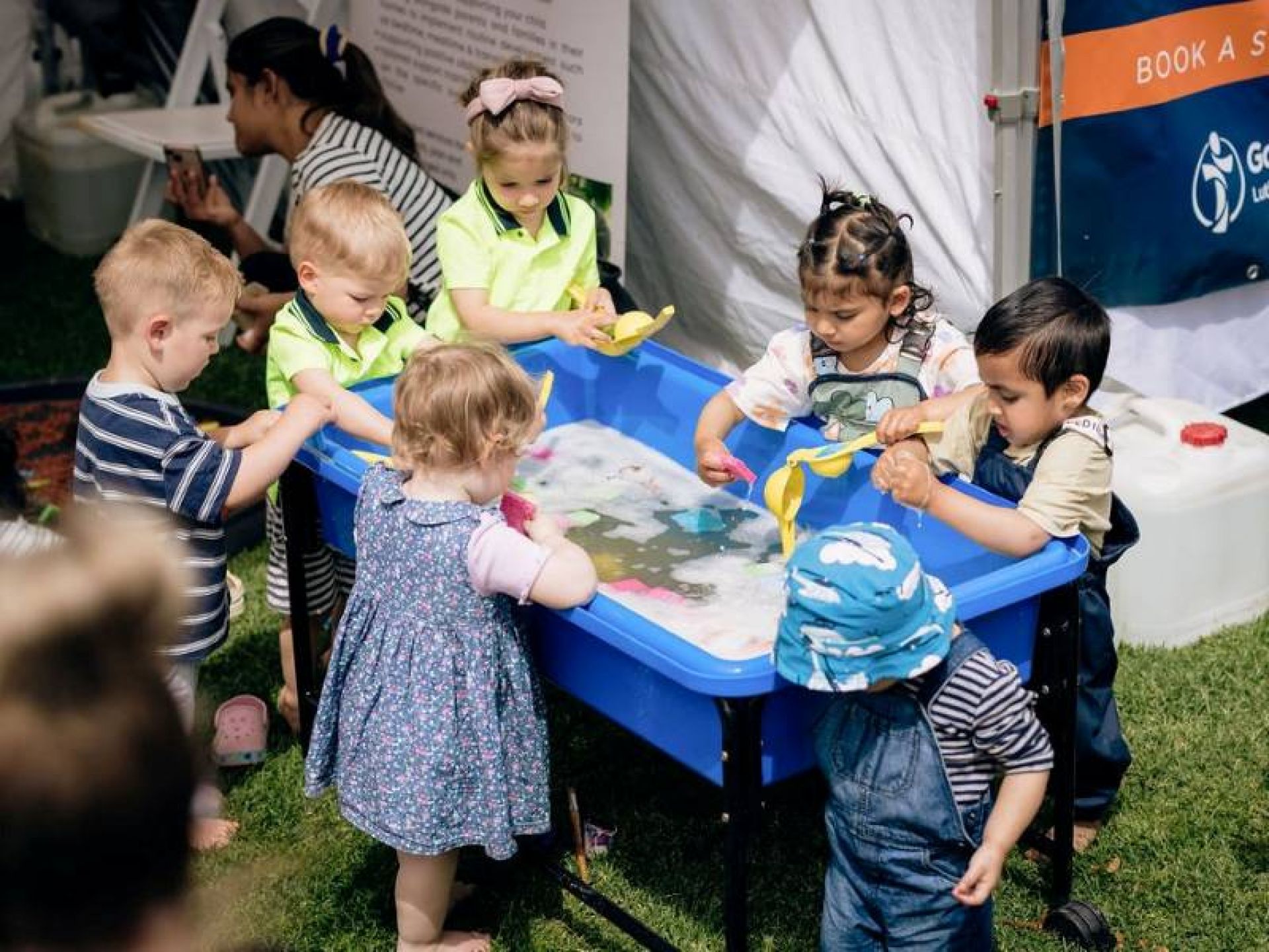 Group of young children engaging in water play