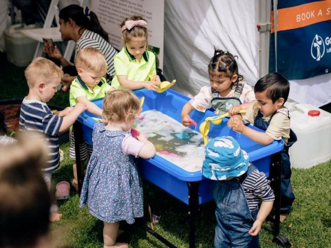 Group of young children engaging in water play