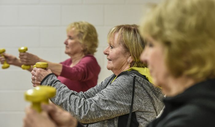 Three ladies using hand weights