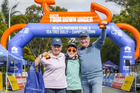 Family near Tour Down Under banner