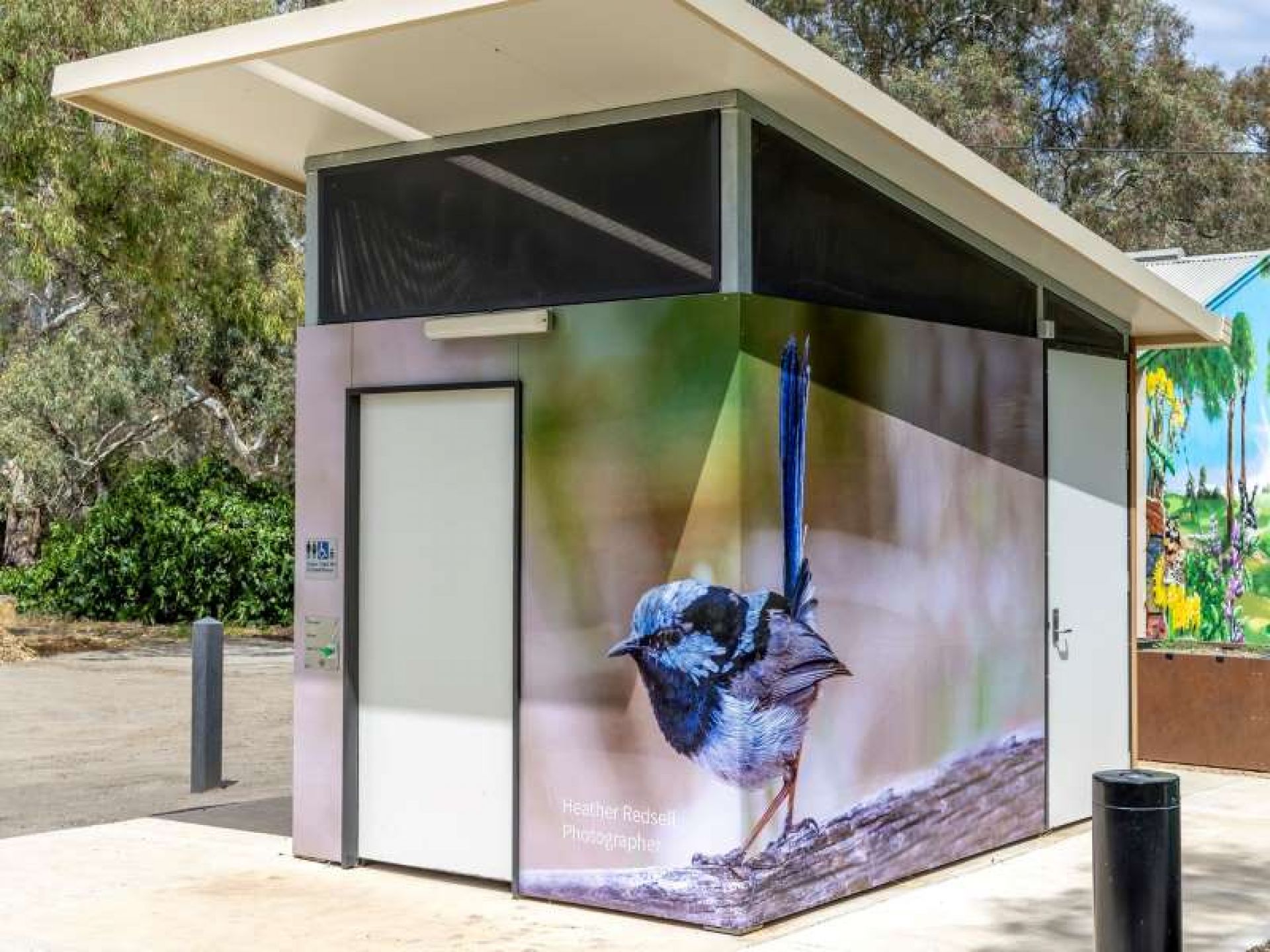 Toilet block wrapped in photo of a bird
