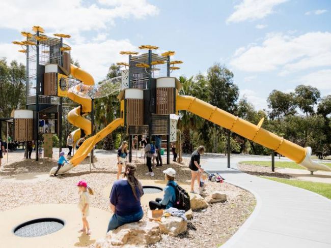 Large playground climbing structure with enclosed slide