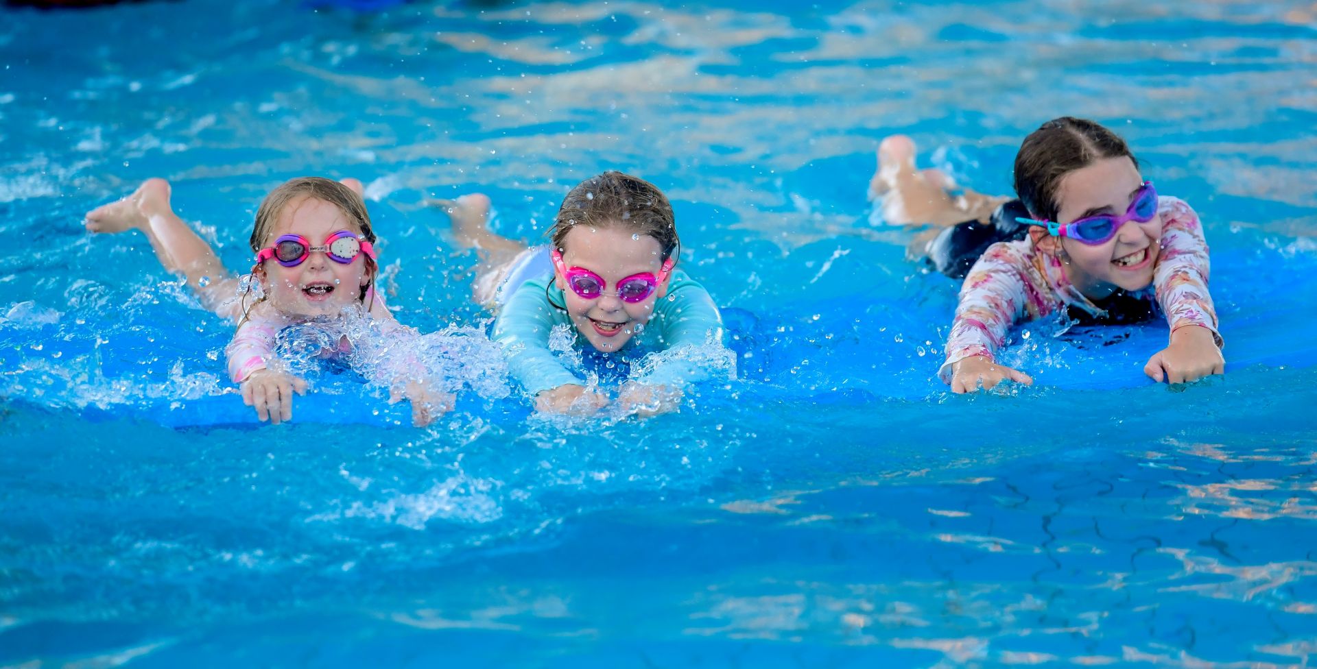 Three children swimming in Waterworld pool