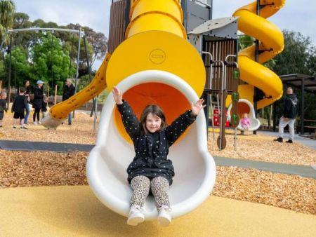 Child coming out of the large enclosed slide tube