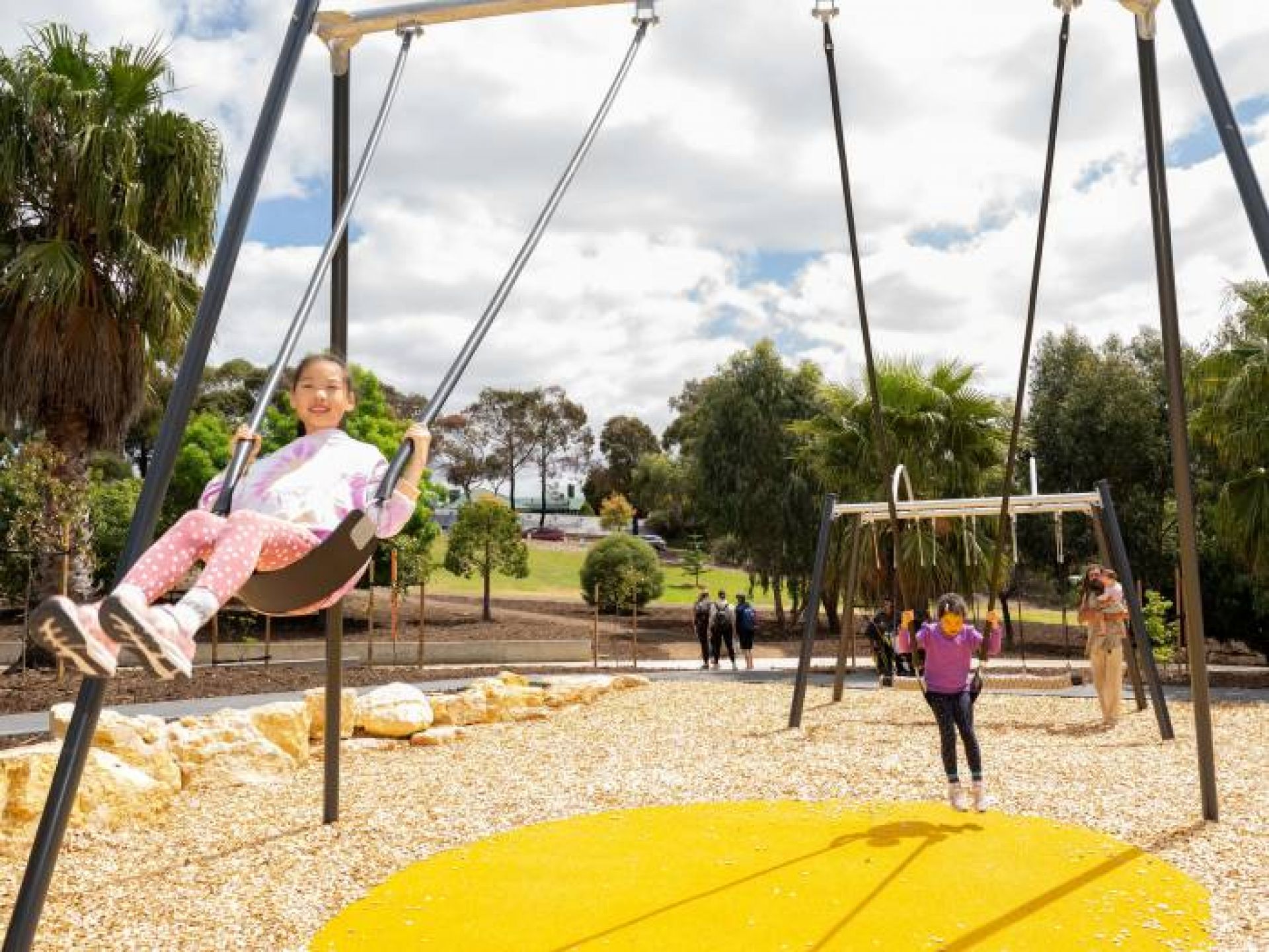 Children playing on playground swings