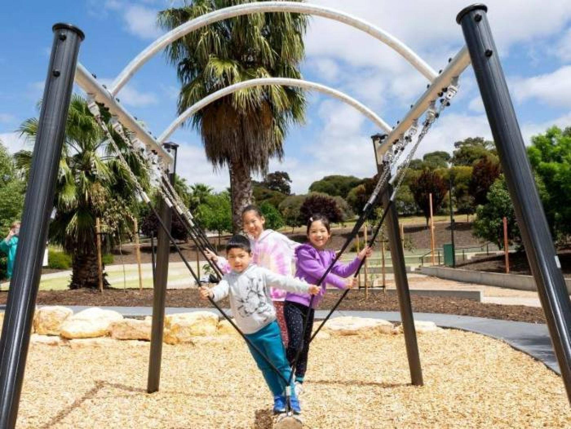 Children playing on a log swing