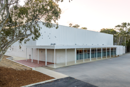 Exterior of a sports hall, surrounded by paved areas