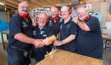 Five men in a workshop