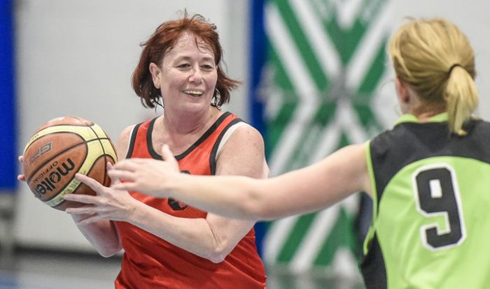 Lady playing basketball