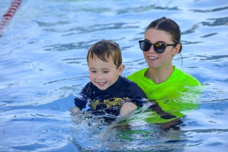 Swimming instructor with child