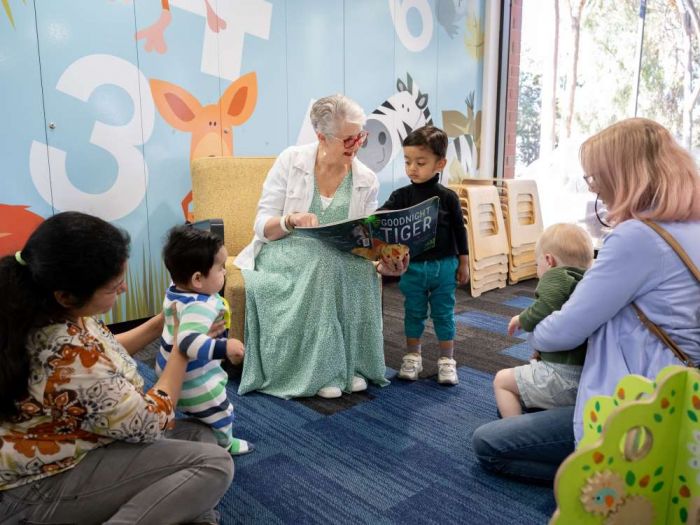 Person reading to young children