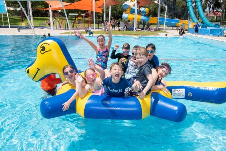 Children on large pool inflatable