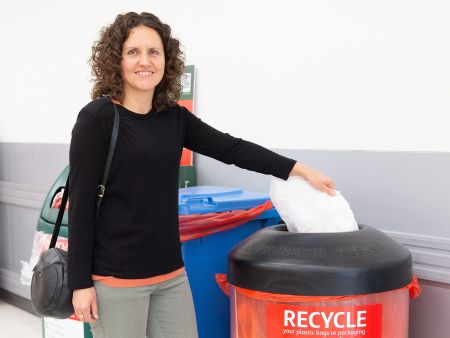 Resident placing soft plastics into bin