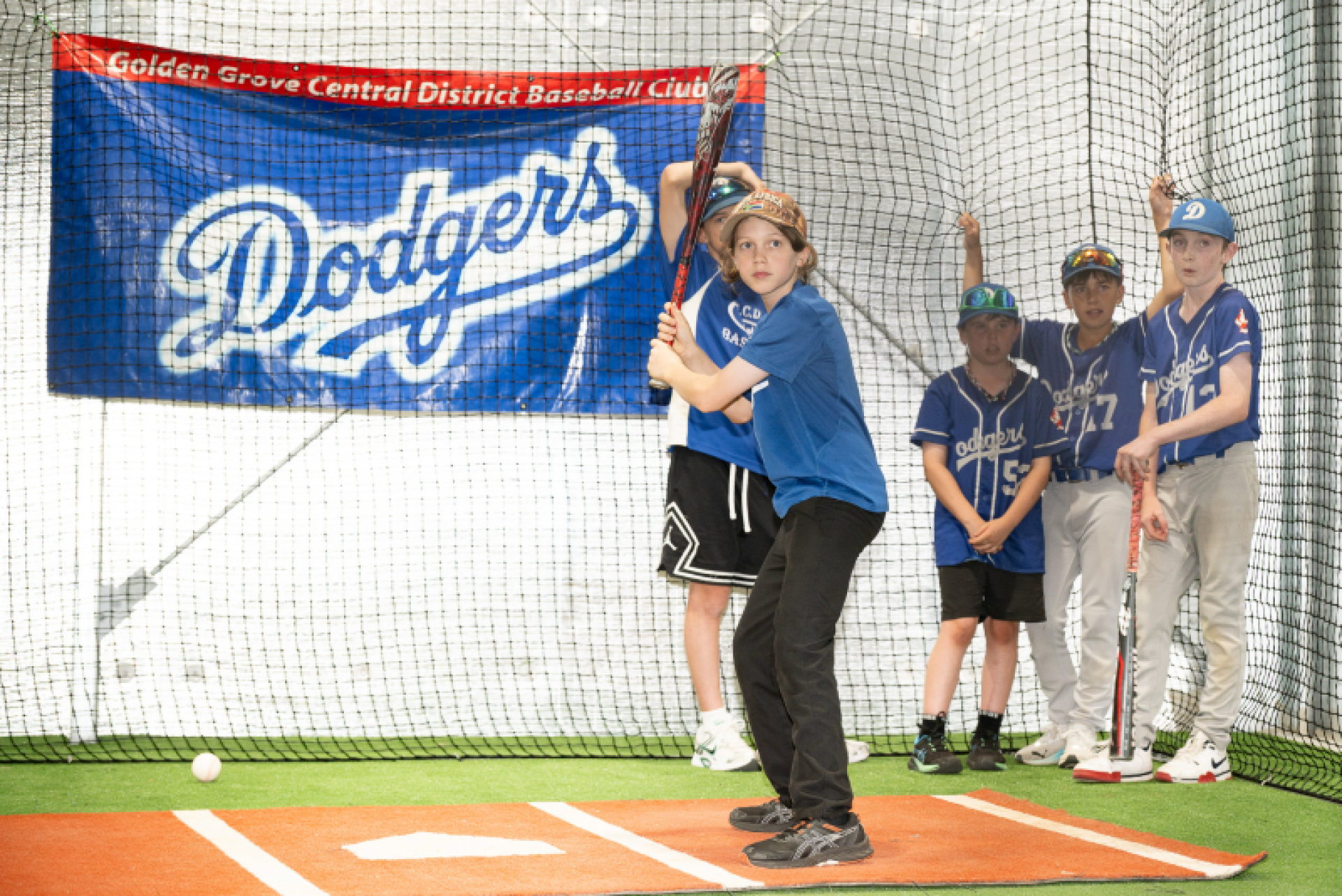 Young person playing indoor baseball